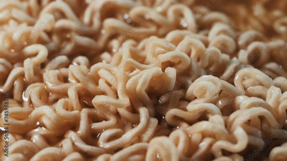 Instant noodles in a bowl moving with fork in slow motion Instant noodles in a bowl moving with fork in slow motion