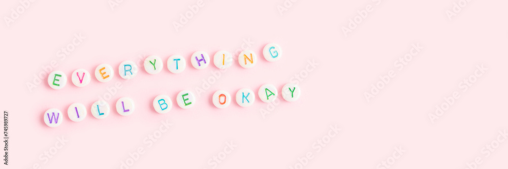 Everything will be okay. Banner with quote made of round beads with letters on a pink background. Place for text.