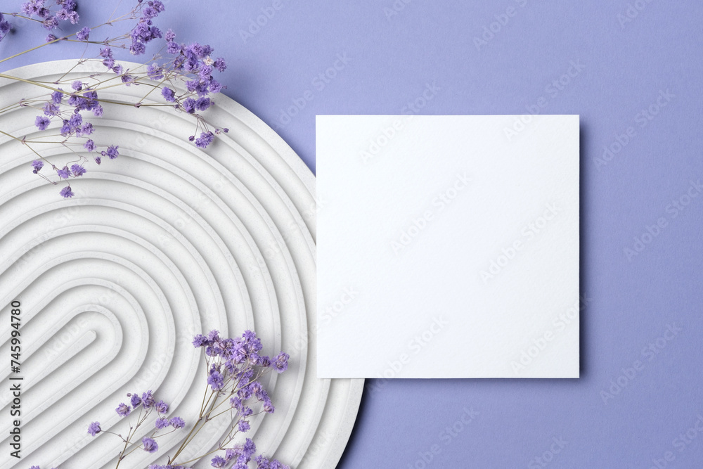 Blank square paper card mockup with copy space and dry gypsophila flowers decor on lavender color background Blank square paper card mockup with copy space and dry gypsophila flowers decor on lavender color background