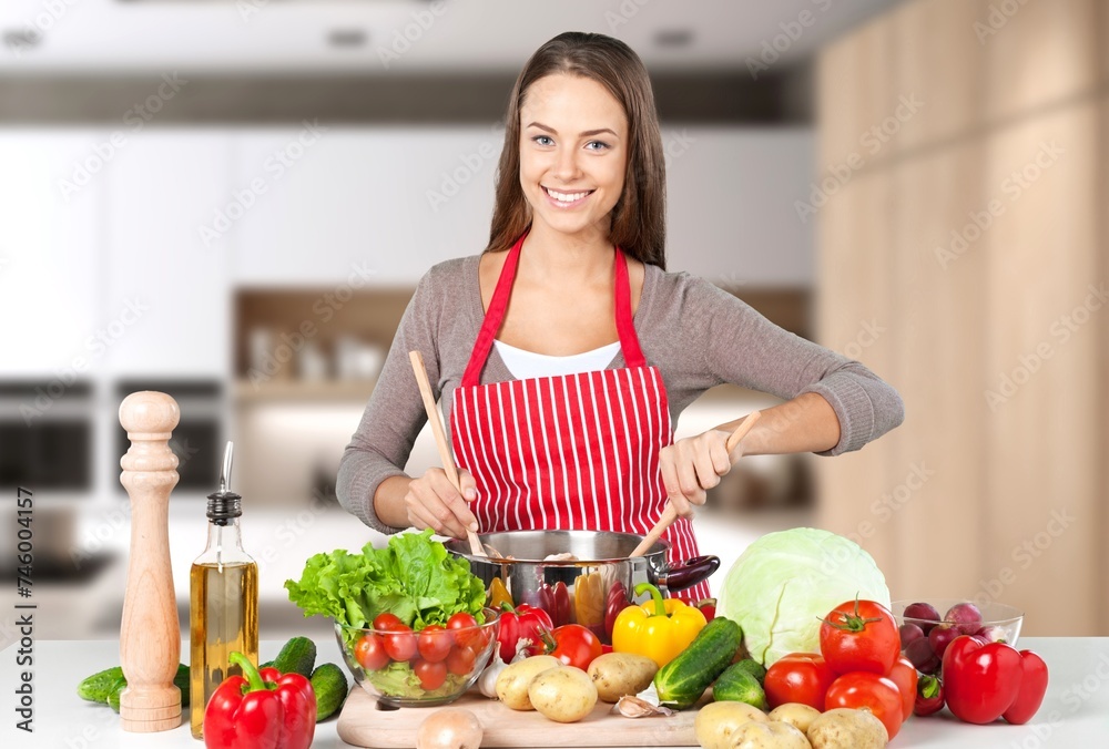 Young female cooking in modern kitchen