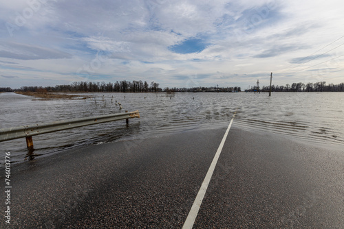 flooded road  early spring flood  river overflowing its banks  environmental pollution  ecology