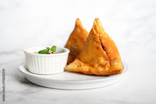 Samosa served with tomato sauce- Indian vegetarian appetizer, selective focus