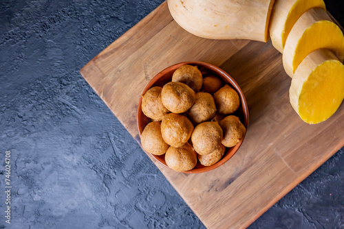 Pumpkin fritters on a table. Accompanied by an anco pumpkin. photo