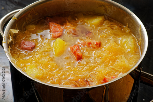 Cabbage soup in cooking pot photo