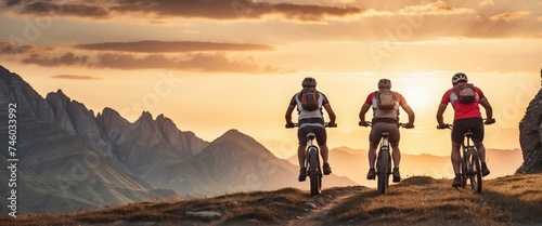 Exploring Majestic Peaks: Captivating Low-Angle Shot of Cross-Country Bikers Embarking on a Mountainous Adventure During the Sunset