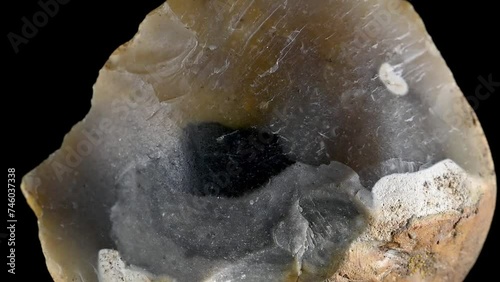 Flint - sedimentary cryptocrystalline form of quartz, rotating against a black background photo