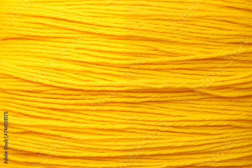 Yellow background made of knitting threads. Abstract background made of yarn