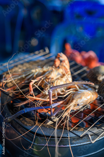 Grilled shrimp, a seafood delight on ice, with a mix of fresh crustaceans showcasing red and white hues, capturing the essence of a delicious seafood meal