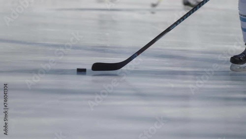 Hockey player skating around on an outdoor ice rink with a stick and puck
