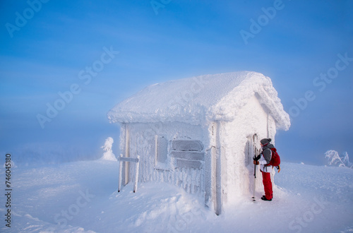 Woman snowshoeing in snowy mountain in Lapland Finland