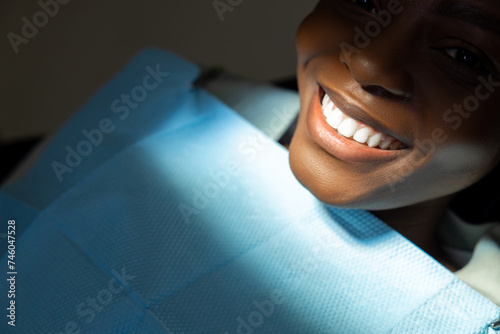 Multicultural female patient with open mouth at dentist office fixing her teeth