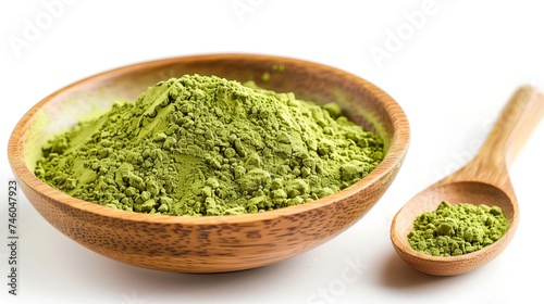 Matcha green tea powder on a wooden spoon in a bowl, isolated on white