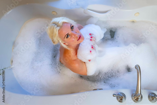 Bathing Elegance: Serene Moments with a Blonde Beauty in a Stylish Round Home Bathtub