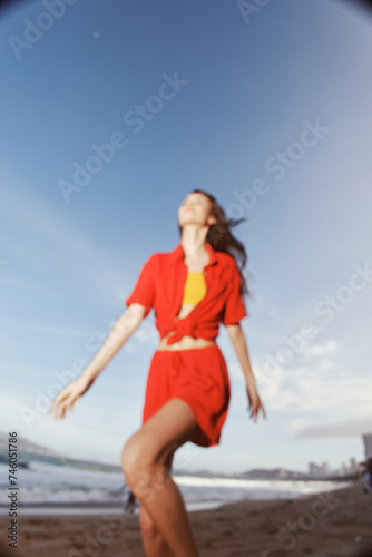 Joyful Summer: A Smiling Woman Dancing with Freedom and Emotion on a Beautiful Beach.