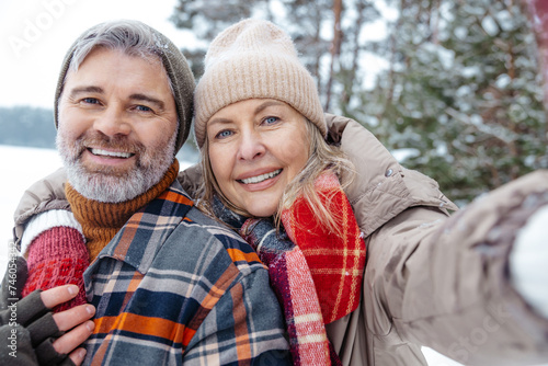 Mature couple looking happy and making selfie