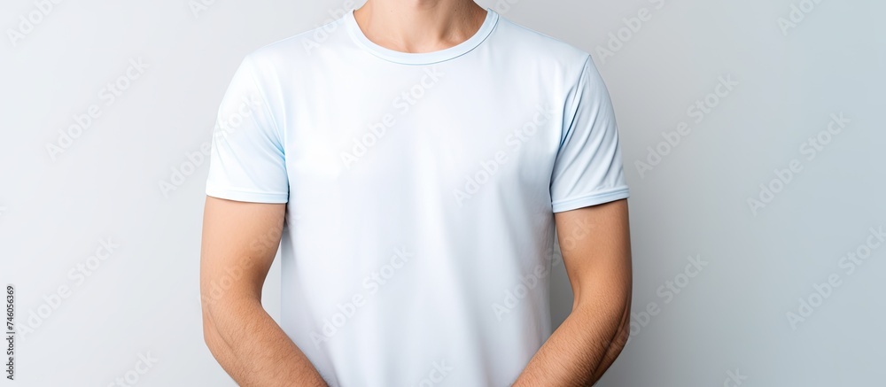 Confident man poses in crisp white shirt and jeans against blank backdrop Confident man poses in crisp white shirt and jeans against blank backdrop