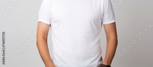 Confident Man Posing with Crossed Arms in Stylish White and Blue T-Shirt on White Background