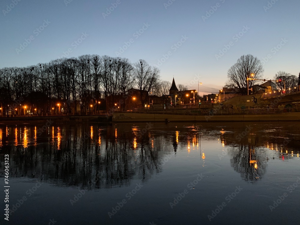 View of the city Tartu reflect in river Emajõgi during sunset, Tartumaa, Estonia, November 2019