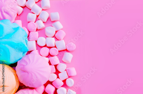 Pink blue white marshmallows on pink background Sweet marshmallow colored candy sweets sweet powder Top view Flat lay Copy space Birthday card Girl