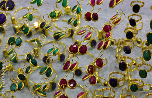 bracelets with precious colored stones in the display case of costume jewelery