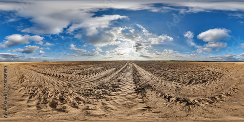 360 hdri panorama view on no traffic gravel road among fields in spring day with beautiful clouds in equirectangular full seamless spherical projection, ready for VR AR
