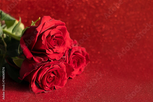 Bouquet of red roses on a red romantic background. Valentine s day or wedding background