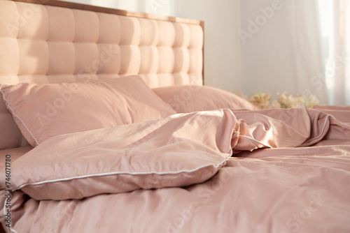 wrinkled light pink bed linen morning routine