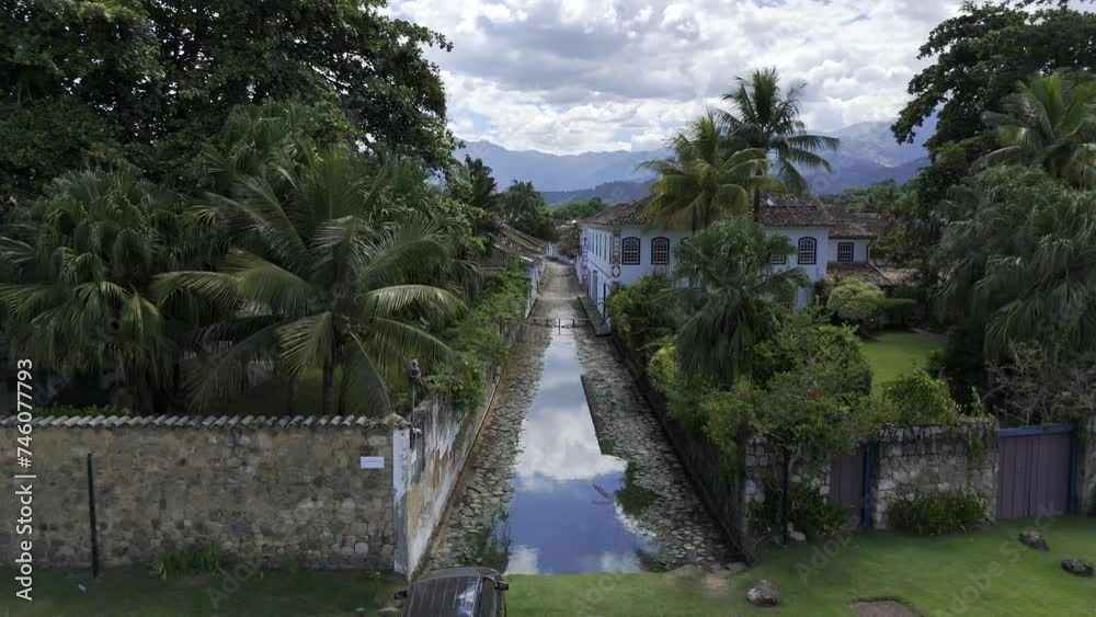 Aerial shot drone flies low over flooded street at the height of the two story houses Aerial shot drone flies low over flooded street at the height of the two story houses