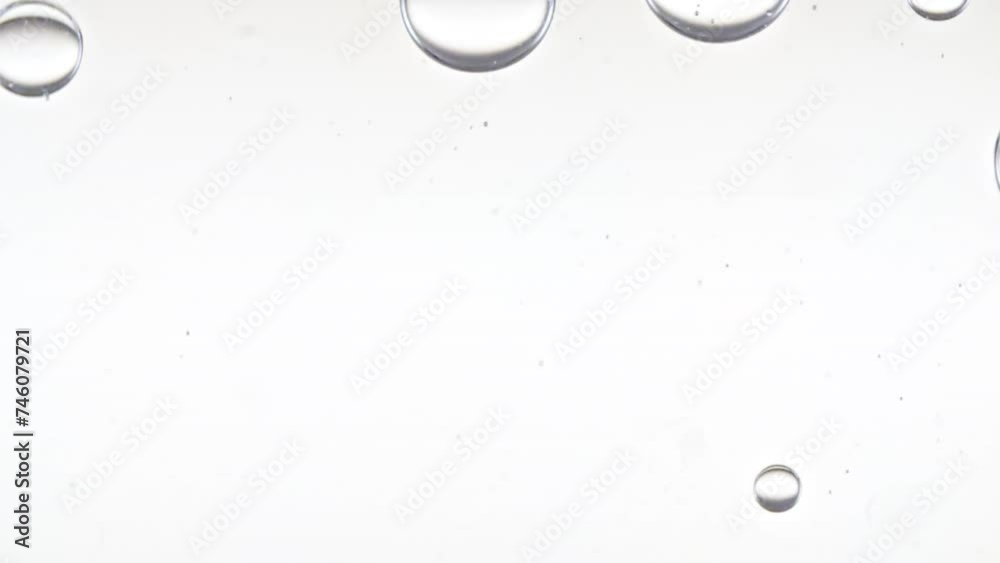 Clear Bubbles Form and Float to Another Ones on Transparent Surface on White Background. The Medicine Concept, Health Care, Body Care Cosmetics. Macro Shot. Slow Motion. High quality FullHD footage
