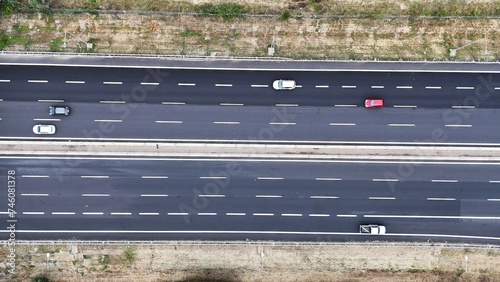 Aerial view of asphalt road with the rural area on both sides, the intercity highway was established between agricultural lands