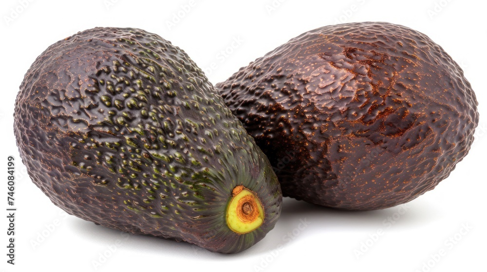 a couple of avocados sitting next to each other on top of a white surface on top of each other. a couple of avocados sitting next to each other on top of a white surface on top of each other.