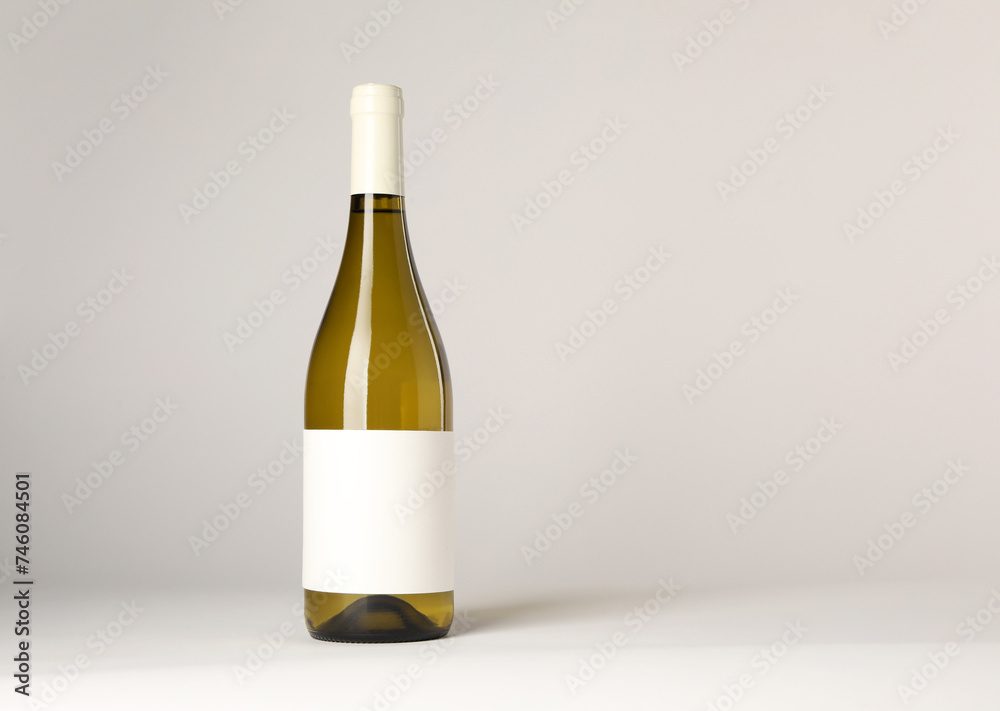 Bottle of tasty wine on white background, space for text Bottle of tasty wine on white background, space for text