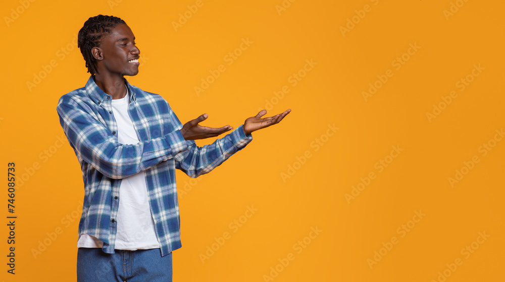 Check This. Black Guy Pointing Aside At Copy Space With Two Palms Check This. Black Guy Pointing Aside At Copy Space With Two Palms