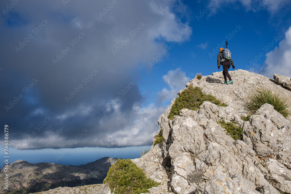 lonely woman on the ridge, ascending to Serra Des Teixos, Escorca, Mallorca, Balearic Islands, Spain