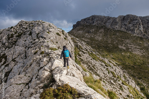 lonely boy on the ridge, ascending to Serra Des Teixos, Escorca, Mallorca, Balearic Islands, Spain