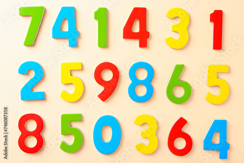 Colorful numbers on beige background  flat lay