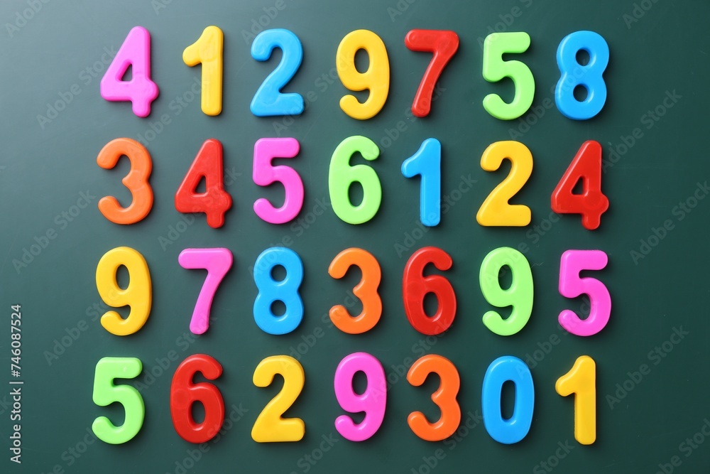 Colorful numbers on green background, flat lay Colorful numbers on green background, flat lay
