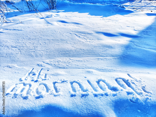 Inscription Hi, written on white background of the snow. Top view. Flat lay. New year and Christmas. Greeting morning, day, weather, sun, people