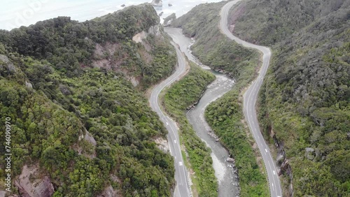 aerial panorama of the west coast of new zealand south island; winding road next to turquois water, mighty cliffs and little islands, ten mile creek near greymouth and paparoa national park photo