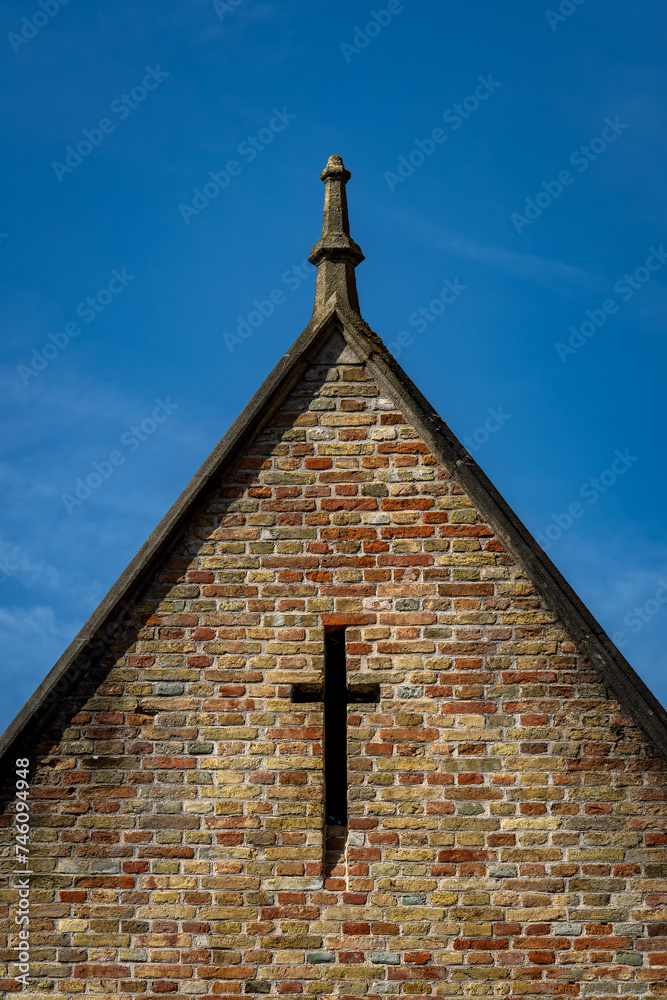 Close up on the top of the Church Of Our Lady In Bruges. Cristian cross