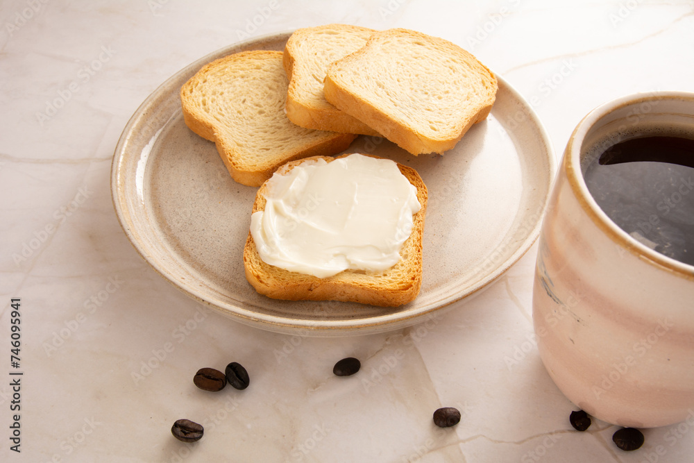 Toast with cream cheese in a marbled background in aerial view Toast with cream cheese in a marbled background in aerial view