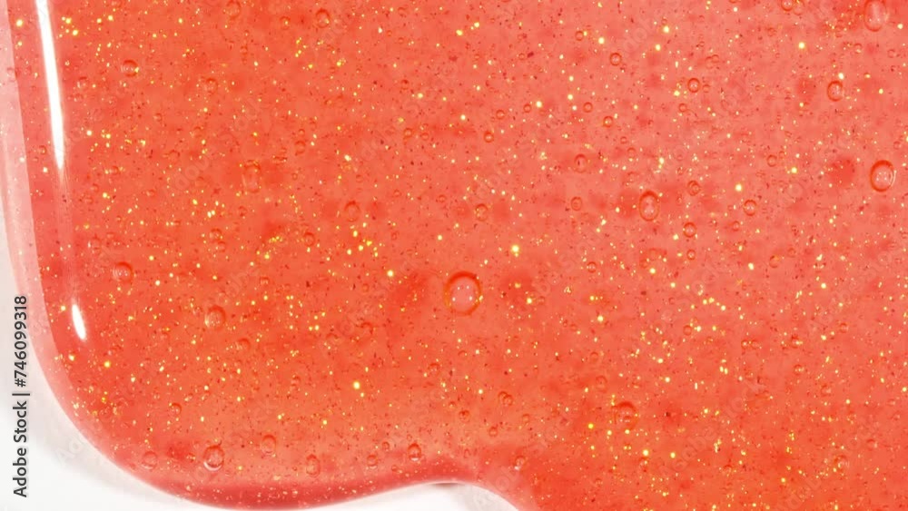 Red Transparent Cosmetic Gel Fluid With Molecule Bubbles Flowing On The White Surface. Macro Shot. Liquid Cream Gel Transparent Cosmetic Sample Texture With Bubbles. High quality 4k footage Red Transparent Cosmetic Gel Fluid With Molecule Bubbles Flowing On The White Surface. Macro Shot. Liquid Cream Gel Transparent Cosmetic Sample Texture With Bubbles. High quality 4k footage