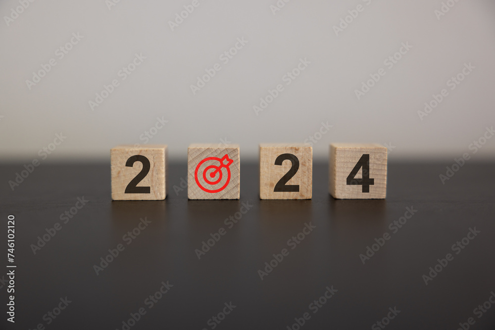 Happy 2024 calendar year with goal and success concepts. Big wood target dart icon and 2024 year number on wooden cube block isolated on white background. Happy new year, big business goals banner. Happy 2024 calendar year with goal and success concepts. Big wood target dart icon and 2024 year number on wooden cube block isolated on white background. Happy new year, big business goals banner.