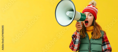 Happy woman, megaphone and speaker in advertising or marketing against a yellow studio background.