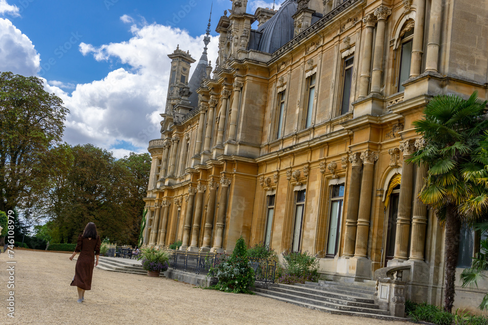 Waddesdon, Buckinghamshire, England, UK - Aug 24th 2022: A woman standing inf front of the Waddesdon Manor House, travel in the UK