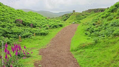 Walking through the lush green landscape of Fairy Glen, Isle of Skye, Scotland photo