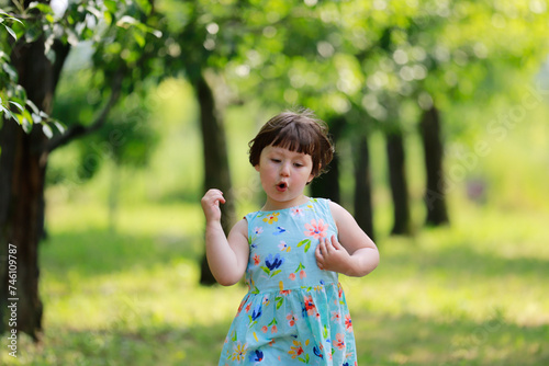 Girl in a dress dancing in the orchard
