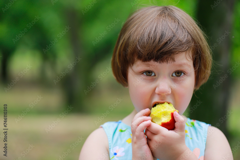 Happy little girl playing under fruit trees Happy little girl playing under fruit trees
