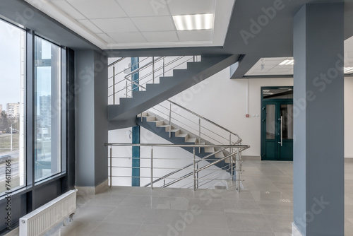 emergency and evacuation exit stairs in up ladder in new empty office building