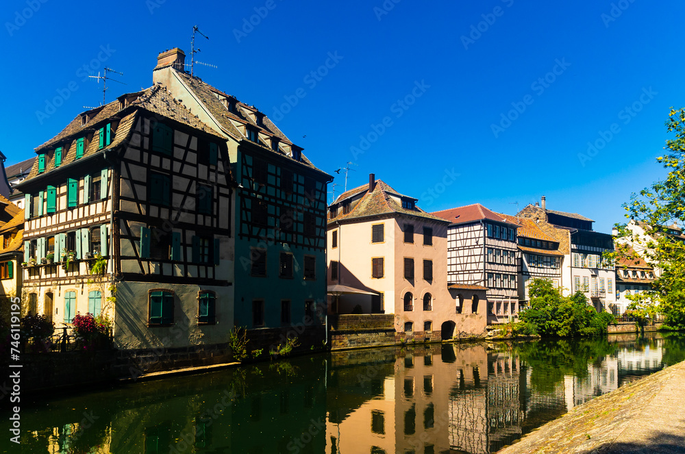 Charming view of residential half-timbered buildings along canals of Strasbourg.